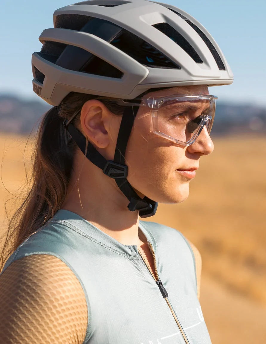 woman wearing a cycling and leatt sunglasses.